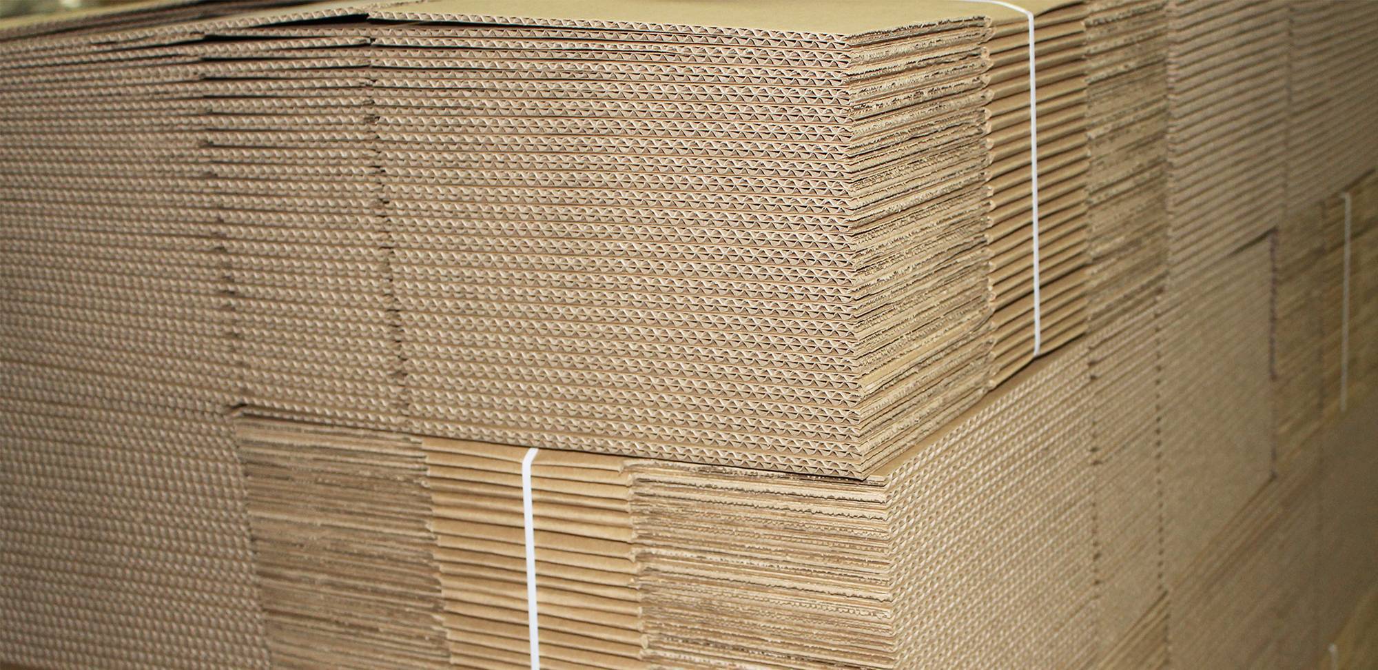 Close up of stacked corrugated boxes strapped together