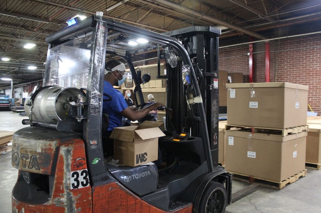 Man operating forklift in warehouse