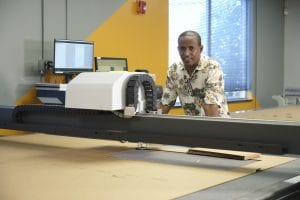 Premier Packaging employee working the CAD table