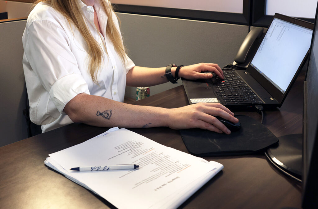 Premier Packaging employee on computer in office setting