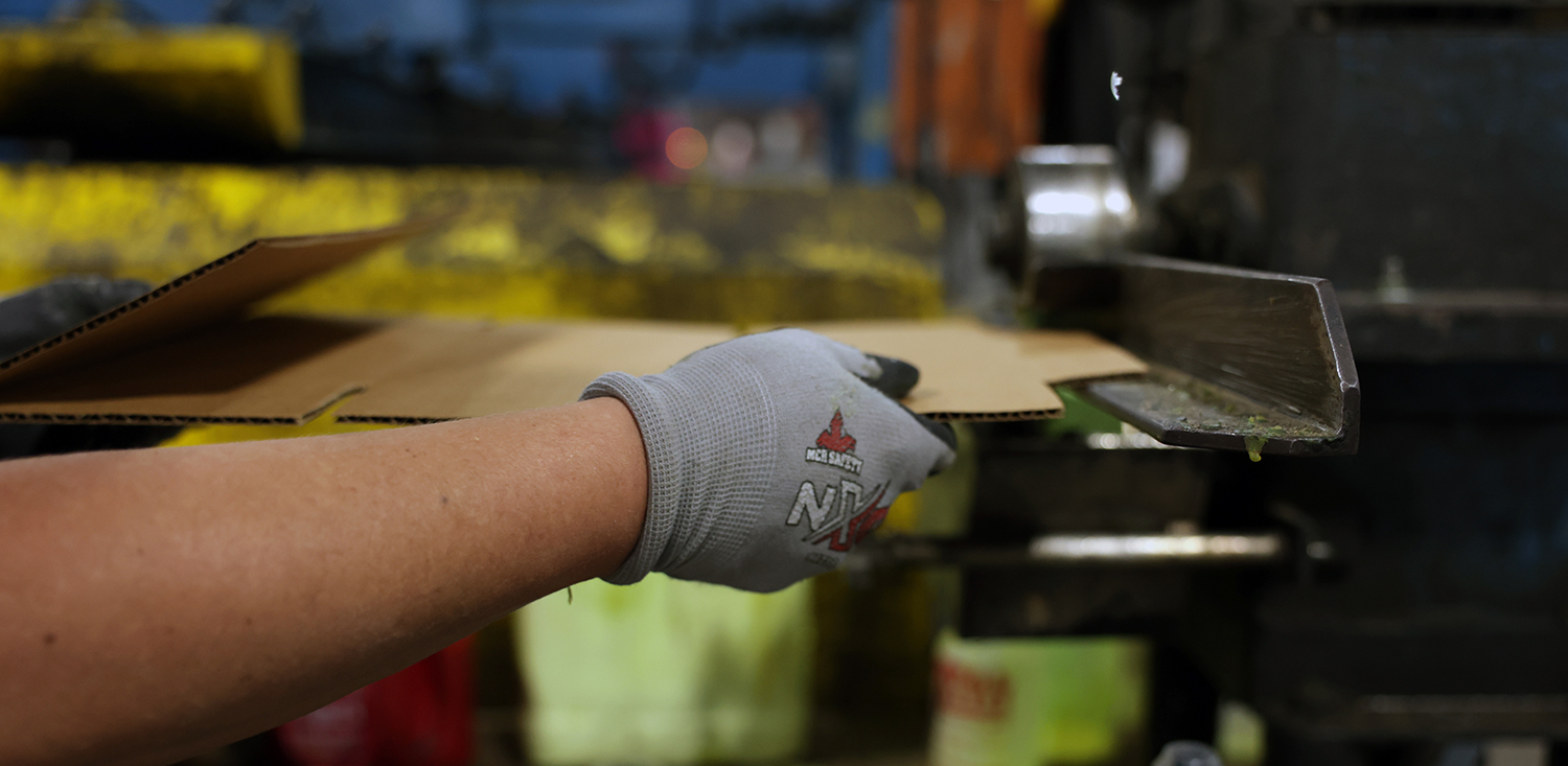 Premier employee working on box machine