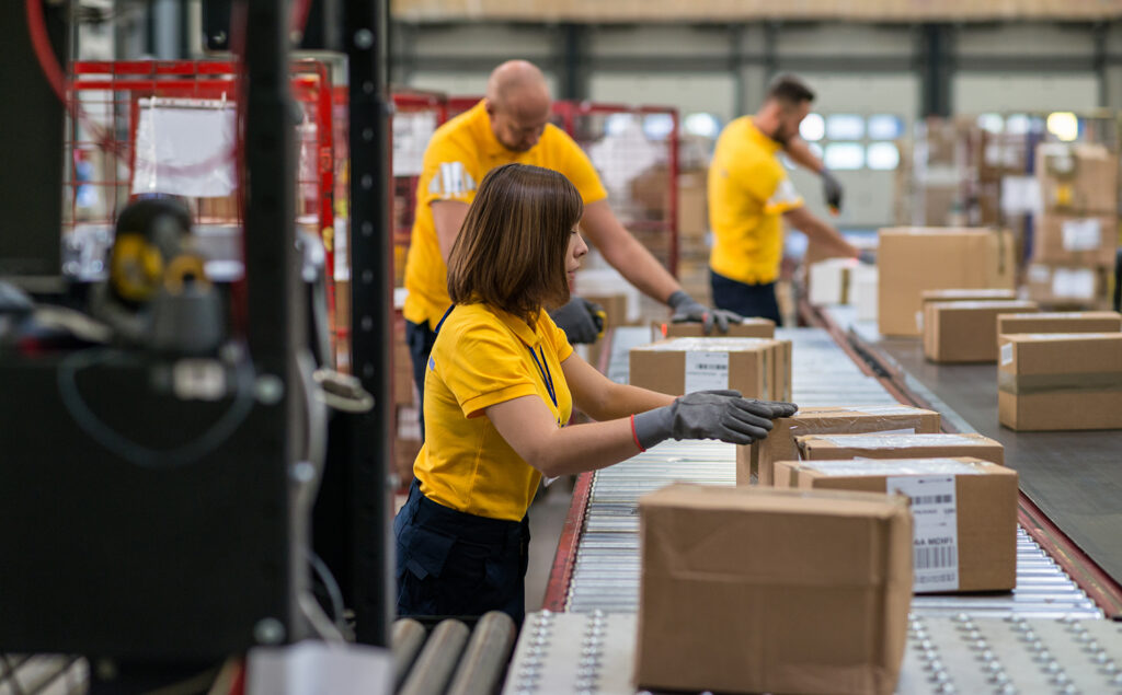 Scanning And Checking Boxes in fulfillment center; 3PL logistics; logistics services; premier fulfillment