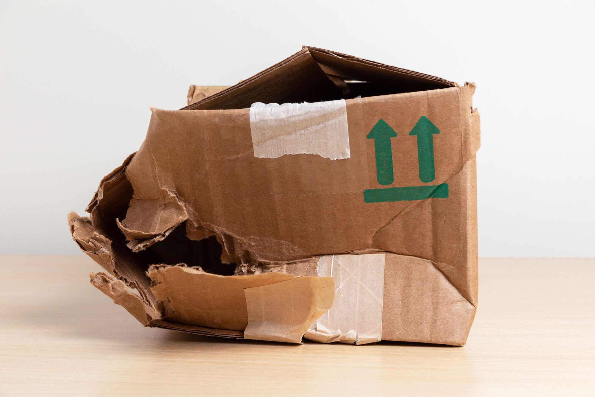 Empty torn and wrinkled cardboard box. Concept Damaged Packaging
