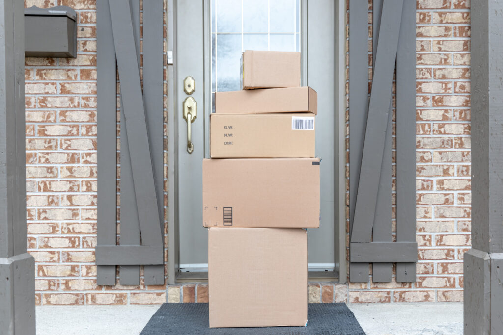 Pile of packages left on front porch; corrugated packages; Corrugated boxes