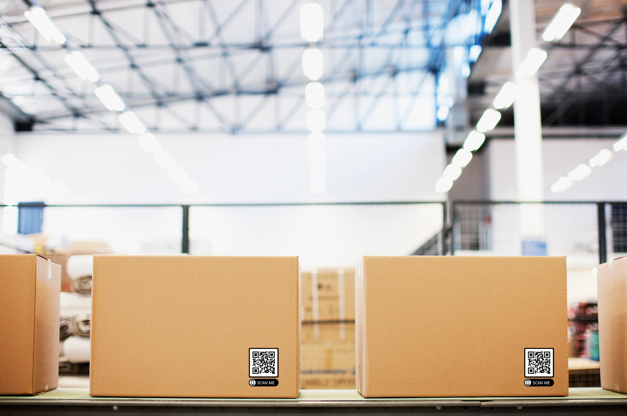 Boxes with QR Code on conveyor belt in warehouse.