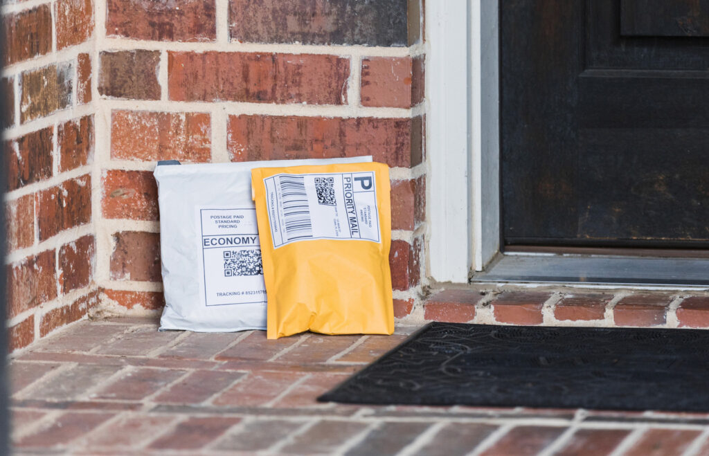 Paper mailers and poly mailers on front porch