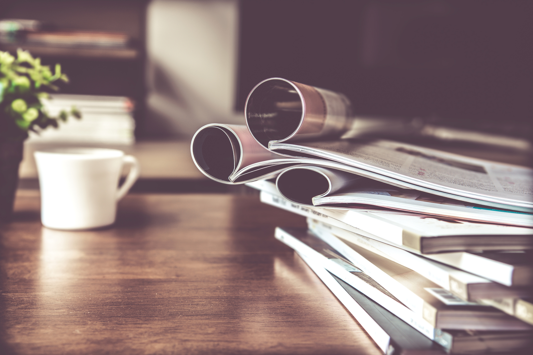 Stacks of magazines on a coffee table