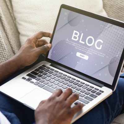 Professional blogger working on his new post on his laptop; blogs about everything packaging including packaging solutions