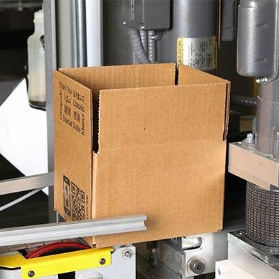 Close up of box in case erector; Warehouse equipment; packaging equipment; automation