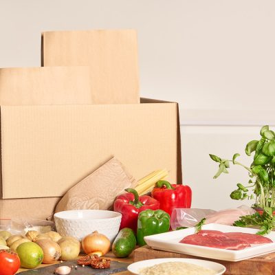 Corrugated box with food items in front; packaging industries