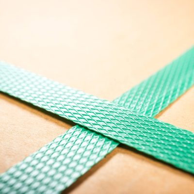 Green strapping criss crossed on box; Warehouse equipment; packaging equipment; automation