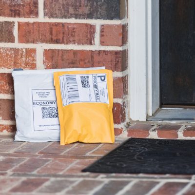 Paper mailers and poly mailers on front porch